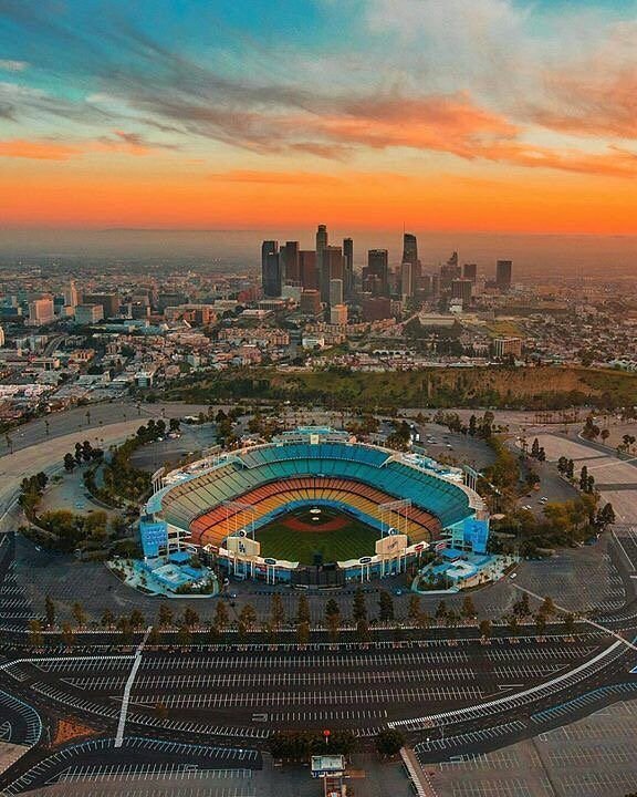 Dodger Stadium at sunset with downtown Los Angeles behind it
